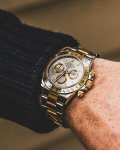 luxury gold and steel chronograph watch on wrist close up
