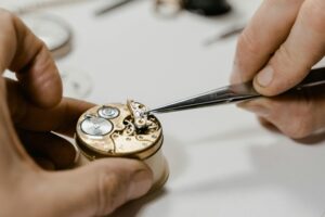 watchmaker repairing mechanical watch movement close up